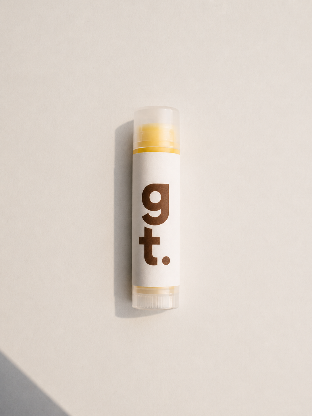 Lip Balm with G T brown logo on it on white background